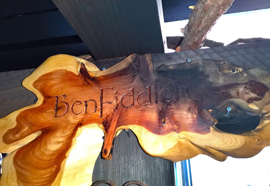 The carved wooden BenFiddich sign hanging outside the bar in Nishi-Shinjuku
