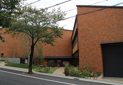The red brick Hasegawa Machiko Art Museum on a quiet street in Sakura-shinmachi