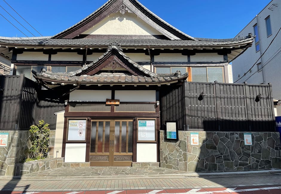 Kanamachiyu in Katsushika, a temple-style sento with a tiled gable roof and a stone-walled front