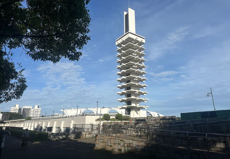 Olympic memorial tower rising over the central plaza of Komazawa Olympic Park under blue sky
