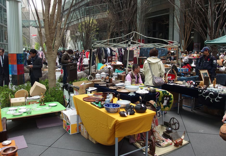 Dealers' stalls of ceramics and old wares under the trees of the Tokyo International Forum plaza during the Oedo Antique Market